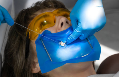 An example of a female patient receiving oral and maxillofacial surgery and wearing a blue mask.