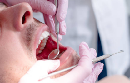 A man getting tooth Extraction And Removal Treatment by Expert dentist using dental tools.
